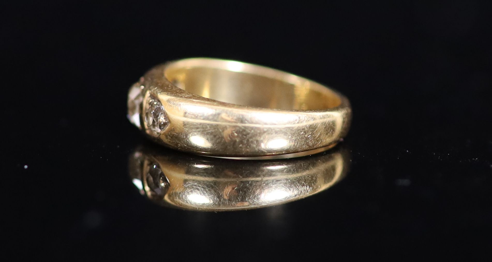 A George V 18ct gold and three stone diamond ring
